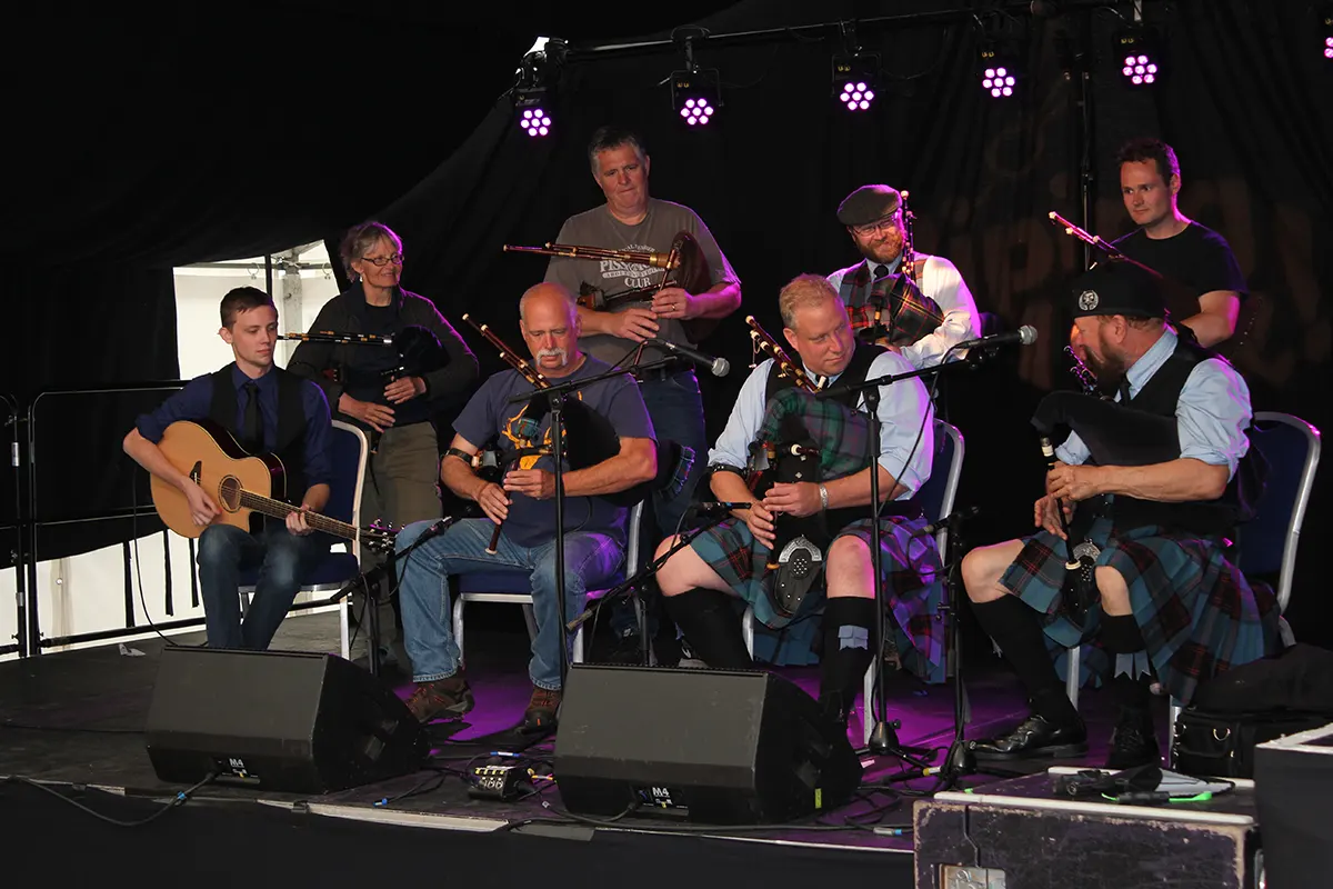 Catamount Pipe Band members playing Scottish Smallpipes at the National Piping Centre in 2018